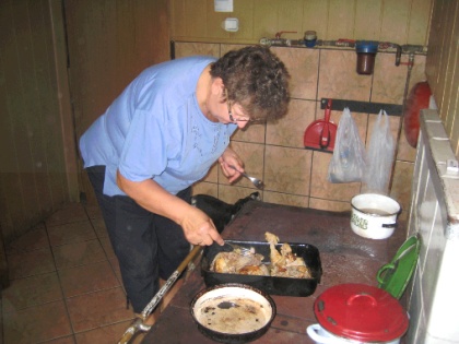 Maria cooking on her stove. The chicken and pork and chicken soup were delicious!