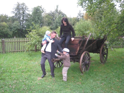 Waldemar Welna, his wife, Ania, and their two children, Marcel (with dad) and Patryk at the Valentine Welna&rsquo;s farmhouse, on the standard transportation of the day, the wooden wagon.